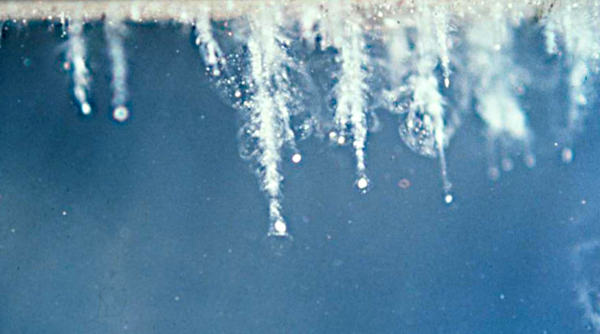 White crystal structures on a blue background.